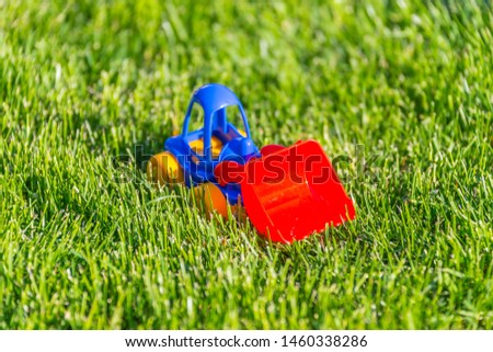 plastic toy car on a green grass