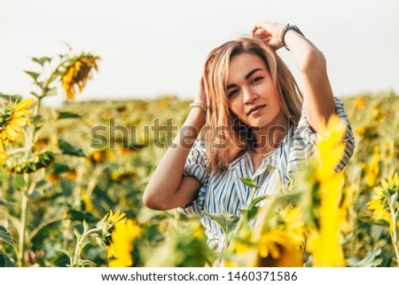 Young girl in a field of sunflowers