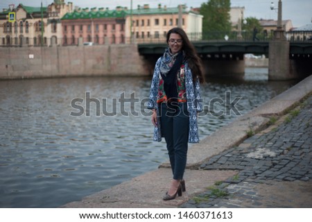 Young, Russian girl, walking on the granite pavement. Saint-Petersburg, Russia