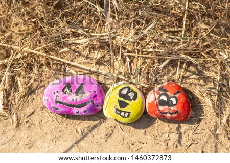 Funny emoticons painted on the rooms. Entertainment traveler. It's time for friends to go to the sea. Funny pictures on the roadside stones.