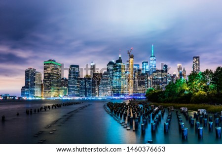 Manhattan panoramic skyline at night from Brooklyn Bridge Park. New York City, USA. Office buildings and skyscrapers at Lower Manhattan (Downtown Manhattan).
