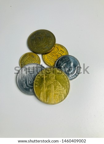 Conceptual Ukrainian money made from mixed coins of different alternate sequential compositions of metal coins of Ukraine on white background is Finance bank and the money Iron screen. 