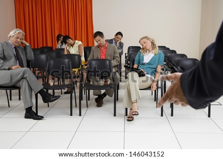 Multiethnic businesspeople sleeping during a seminar in conference room