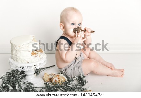Cute adorable happy baby enjoying cake