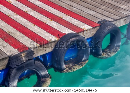 This unique photo shows the departure pier with old car tires overgrown with seaweed. The picture was taken at the airport in Male