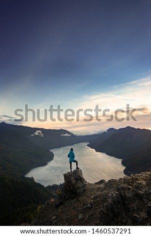 This is the picture of Female Hiker Standing on the Top of Mount Storm King Olympic National Park.