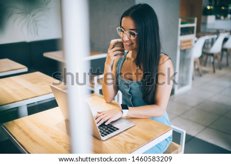 Positive hipster girl spending free time for online shopping in favourite web store happy with received discounts, Ukrainian female freelancer working remotely on modern digital laptop using 4g