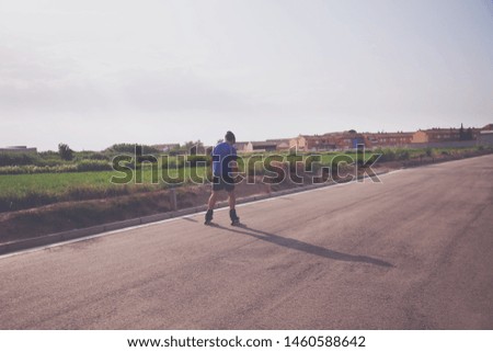 man with inline skates skating on the street