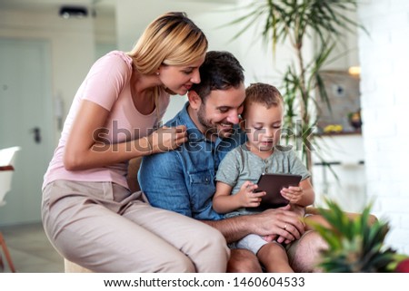 Family enjoying together with tablet at home.
