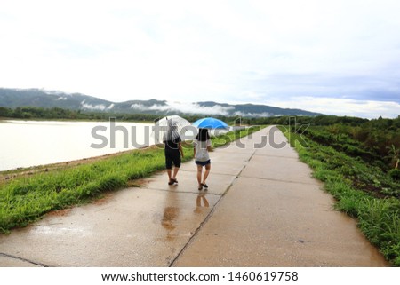 People walking holding rain umbrellas
