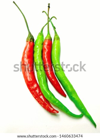 A picture of red and green chilies on white background