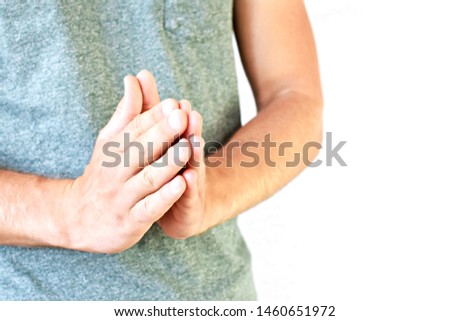 A young man puts his palms together - a gesture that has different meanings in different countries, with the focus on the man's hands