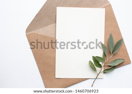 mockup card with plants. invitation card with environment and details Mockup with postcard and flowers on white background.
