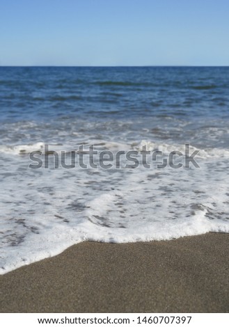 Image of sandy beach, sea and waves