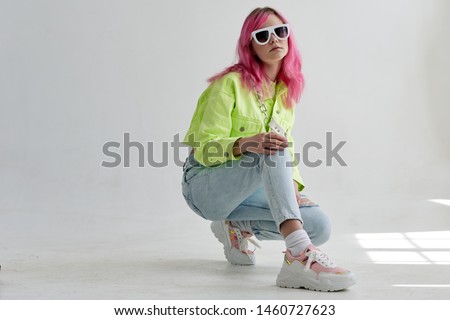woman sitting in glasses with pink hair retro style fashion