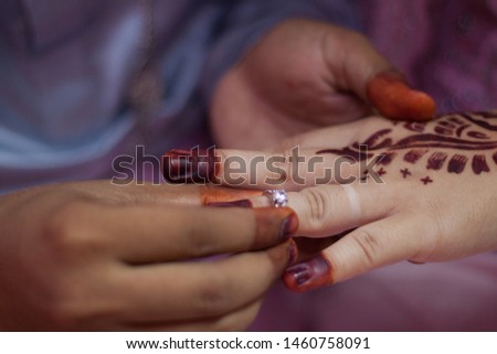 Groom put on the ring to bride hands in Borneo Malay Wedding ring exchange ceremony.