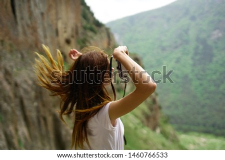 woman with camera in the mountains