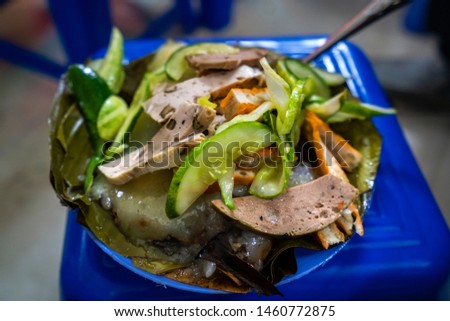 In Hanoi, Vietnamese food, Banh Gio or pyramid shaped rice dough dumpling filled with pork, shallot, and wood ear mushroom wrapped in banana leaf, is delicious street food, dish make from rice flour
