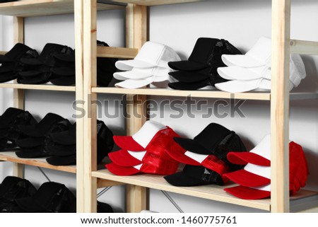 Wooden rack with different blank caps in store