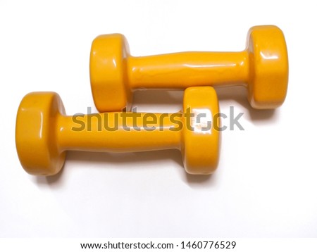 Couple of Yellow dumbbell on white background. Home fitness
