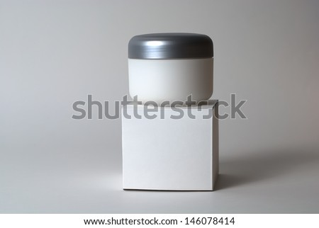 Cream container over blank box