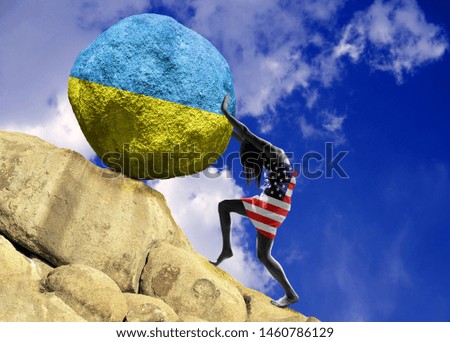 The girl, wrapped in the flag of the United States of America, raises a stone to the top in the form of a silhouette of Ukraine