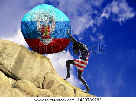 The girl, wrapped in the flag of the United States of America, raises a stone to the top in the form of a silhouette of the flag of the Luhansk People's Republic
