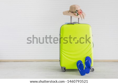 Suitcase with hat, passaport and slippers on white background.Summer travel holiday