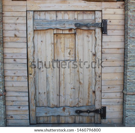 Old wooden door on the old stone wall - Image