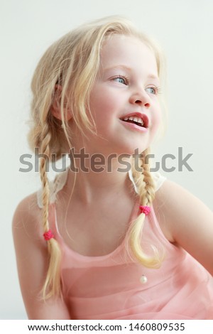beautiful little girl smiling and look outside the picture