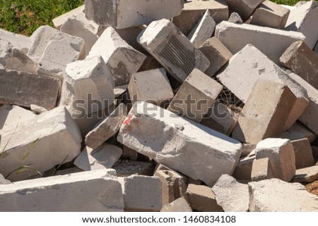 A pile of broken bricks. White bricks roll on the ground. Background stones. Start building. Where to buy building materials.