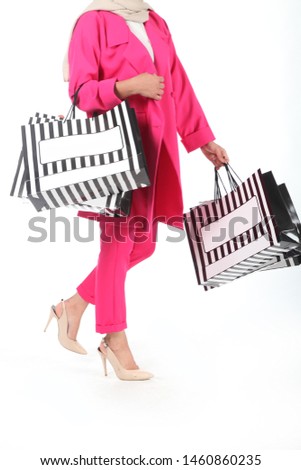 Young woman with shopping bags isolated on white background