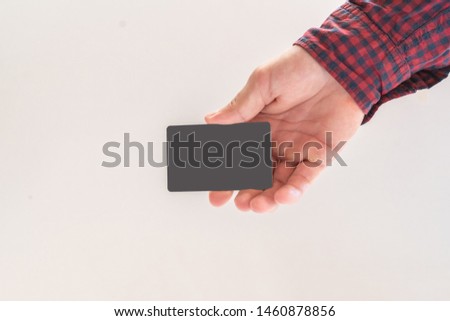 hand holdng a visit card with copy space mockup 