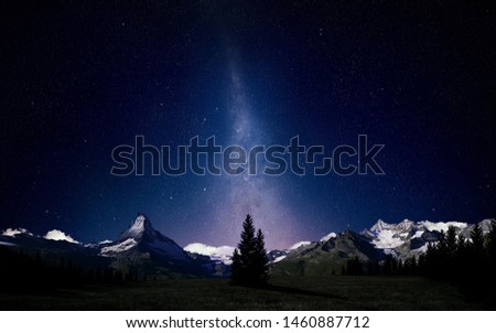 Amazing view of the snow-capped mountains and the sky of a million stars