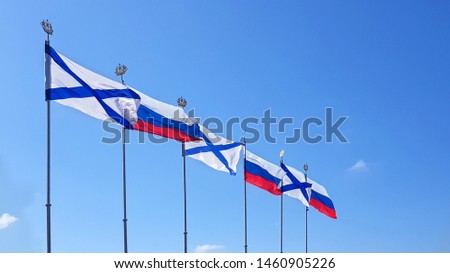 Russian national and Navy Ensign (St Andrews's flag) flags waving on blue sky
