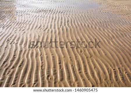 Background of sand on the beach with cover of sea water.