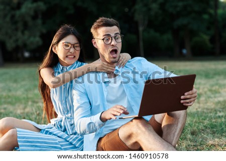 man and woman park laptop nature friendship in life