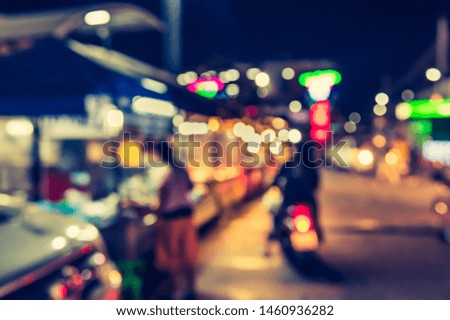 Vintage tone abstract blur image of Street night market with bokeh for background usage .