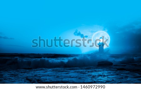 Night sky with lighthouse in the background amazing super blue moon "Elements of this image furnished by NASA