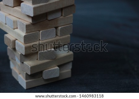 Tower of wooden sticks without focus. Board games for the whole family. Natural materials for solving puzzles and problems . Modern school education