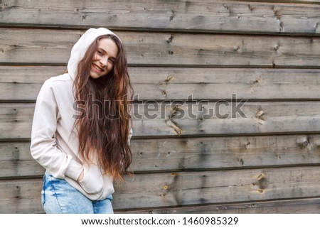 Happy girl smiling. Beauty portrait young happy positive laughing brunette woman on wooden wall background. European woman. Positive human emotion facial expression body language