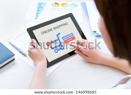 Business person makes a purchase through online shopping application on a modern digital tablet