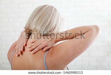 Middle aged woman with a pain in the body. Concept photo with indicating location of the pain. Health care concept