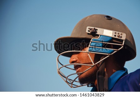 Young man wearing a cricket helmet unique portraits photo