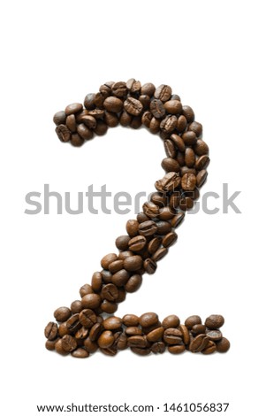 A digit 2 laid out of roasted fragrant coffee beans on a white background