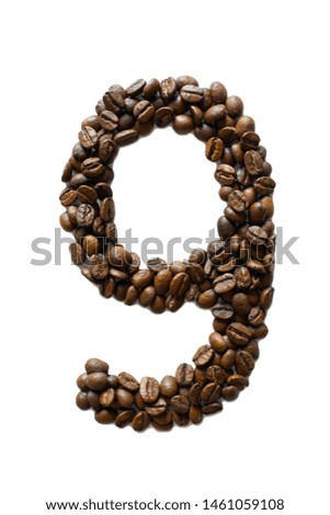  A digit 9 laid out of roasted fragrant coffee beans on a white background
