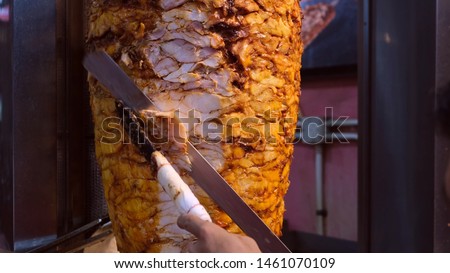 Shawarma. Closeup picture of stacked meat roasting, shawarma