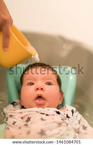 bathing a newborn at home. A picture of a newborn baby from the first bathroom.
