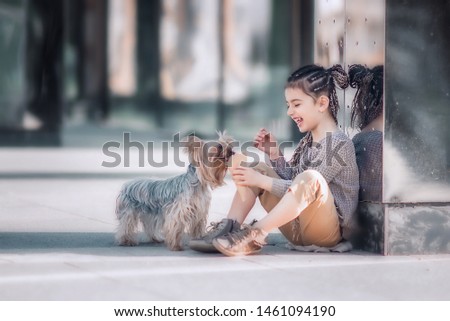 girl feeds dog with an ice cream