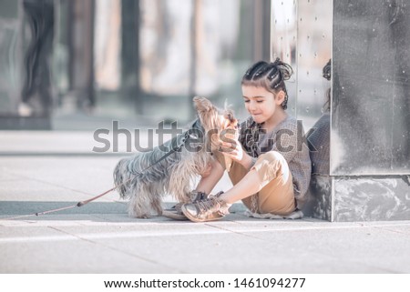 girl feeds dog with an ice cream